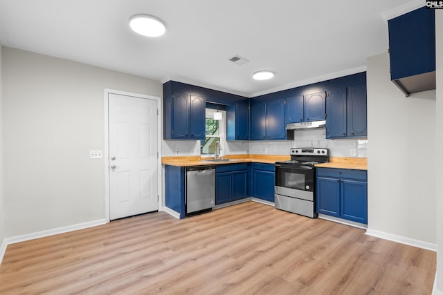 kitchen featuring blue cabinetry, sink, stainless steel appliances, and wood counters