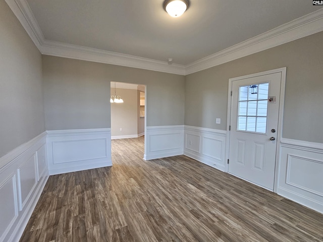 unfurnished room with a notable chandelier, wood-type flooring, and ornamental molding