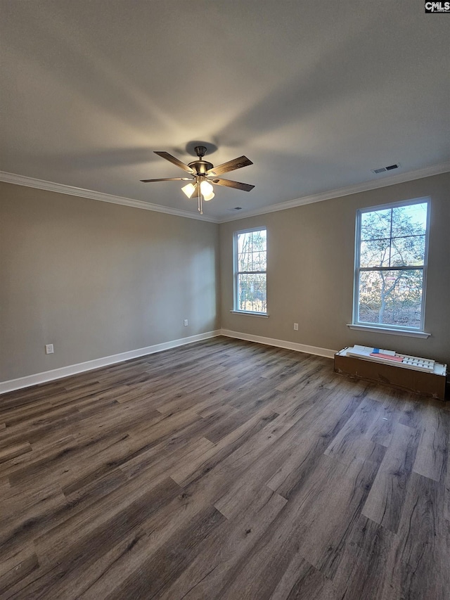 spare room with dark hardwood / wood-style flooring, ceiling fan, and crown molding