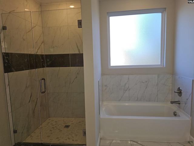 bathroom with a healthy amount of sunlight and separate shower and tub