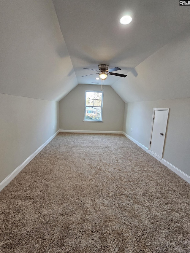 additional living space with carpet, ceiling fan, and vaulted ceiling