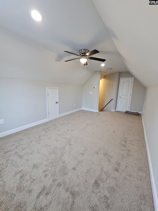 additional living space featuring carpet, vaulted ceiling, and ceiling fan