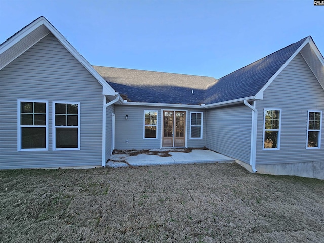 rear view of property featuring a lawn and a patio