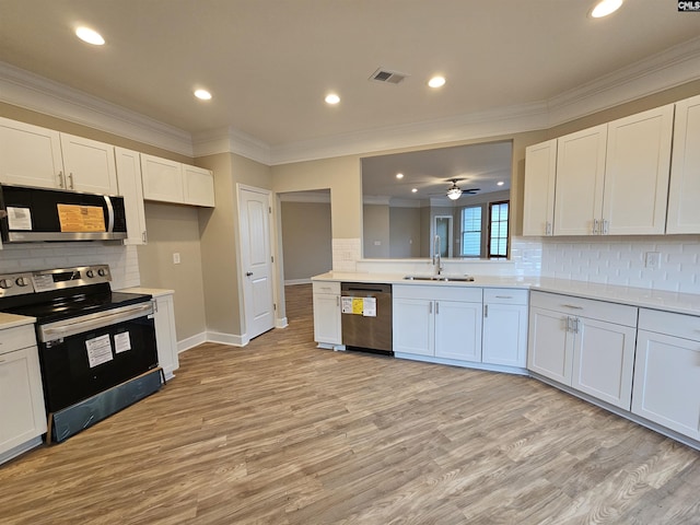 kitchen with white cabinets, appliances with stainless steel finishes, ceiling fan, and sink