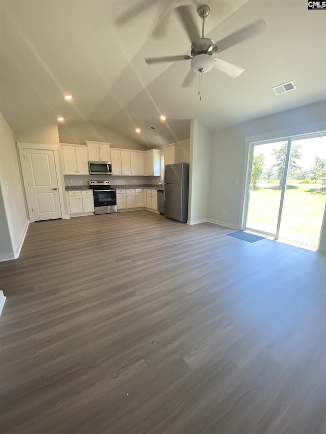 kitchen with dark wood finished floors, visible vents, appliances with stainless steel finishes, white cabinets, and baseboards