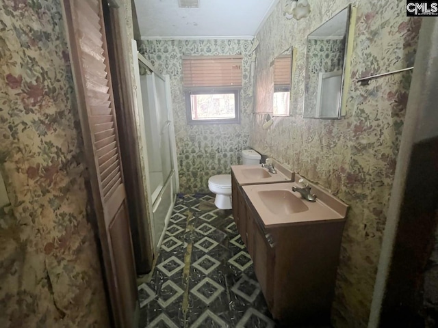 bathroom with crown molding, vanity, and toilet