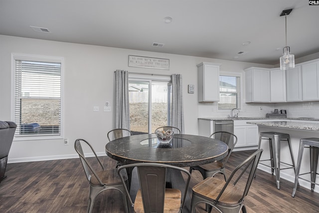 dining area with plenty of natural light and dark wood-type flooring