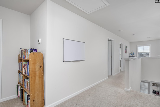 hallway featuring light colored carpet