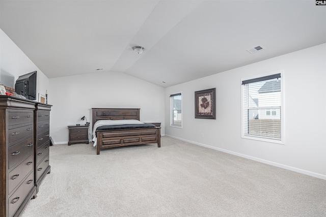 carpeted bedroom featuring lofted ceiling