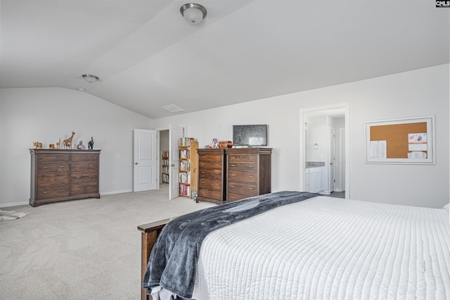 carpeted bedroom featuring ensuite bathroom and vaulted ceiling