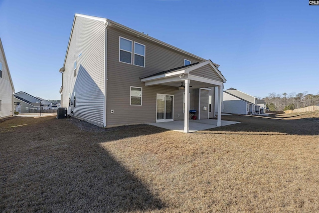 back of property with a patio, cooling unit, and a lawn