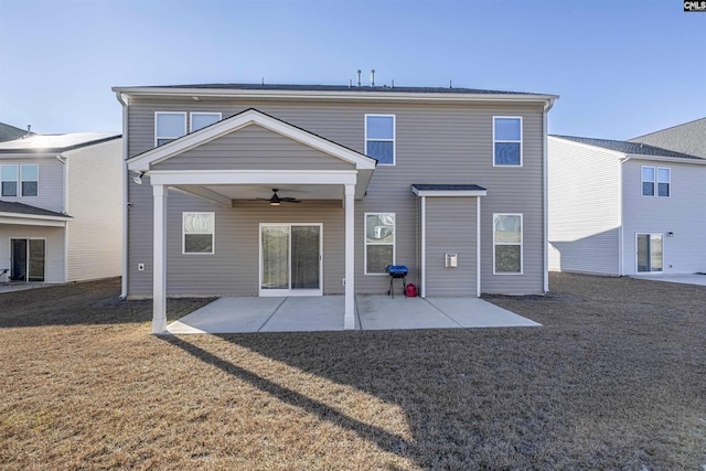 rear view of property with a yard, ceiling fan, and a patio area