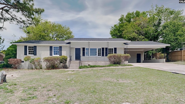 single story home featuring covered porch, a front yard, and a carport