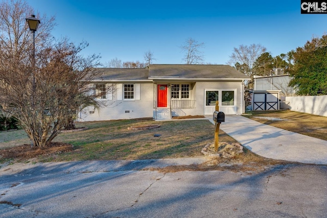 single story home with a storage shed