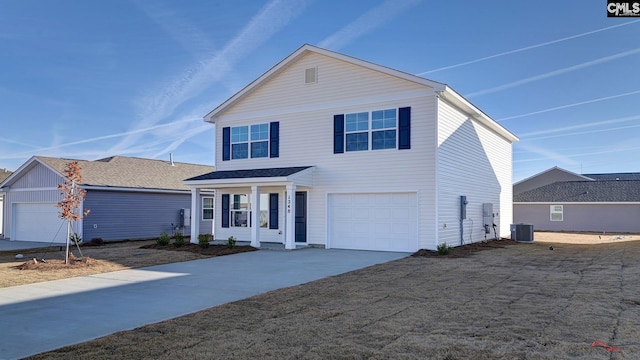 view of front property featuring a porch, a garage, and central air condition unit