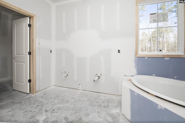 bathroom featuring a tub to relax in