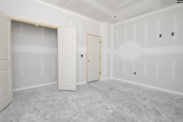 unfurnished bedroom featuring unfinished concrete flooring and baseboards