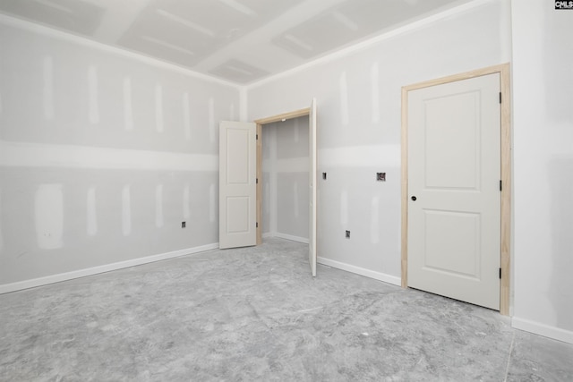 unfurnished bedroom with baseboards and unfinished concrete floors