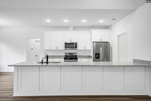1139 Pine Grove Rd, Lugoff, SC 29078 - kitchen with appliances with stainless steel finishes, white cabinets, light stone countertops, and recessed lighting