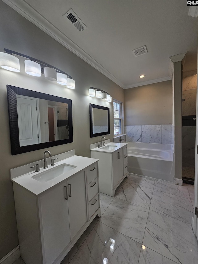 bathroom with a washtub, vanity, and ornamental molding