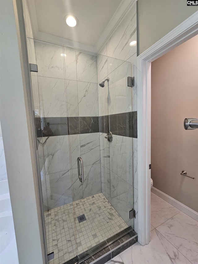 bathroom with an enclosed shower, toilet, and crown molding