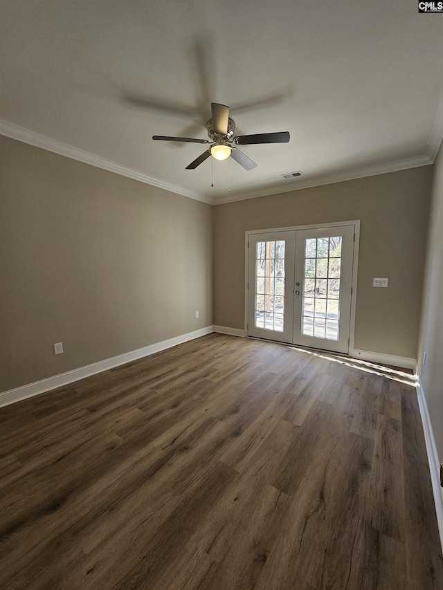 empty room with dark hardwood / wood-style flooring, crown molding, french doors, and ceiling fan