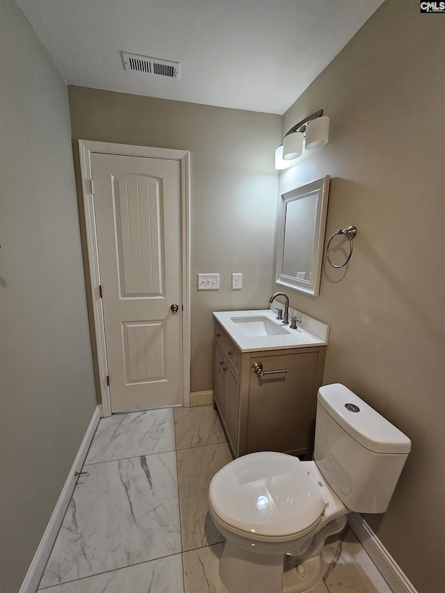 bathroom with vanity and toilet