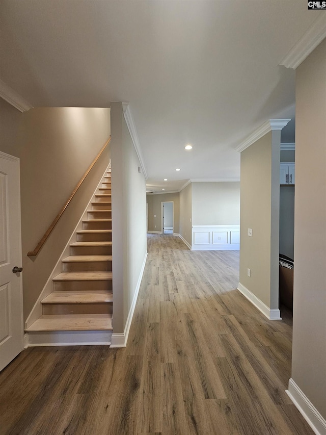 interior space featuring hardwood / wood-style floors and crown molding