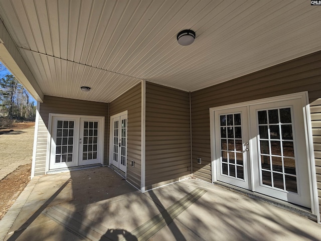 deck with french doors and a patio