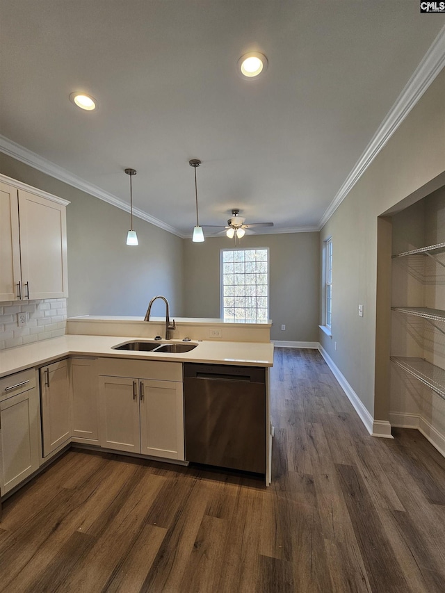 kitchen with stainless steel dishwasher, ornamental molding, sink, decorative light fixtures, and white cabinets