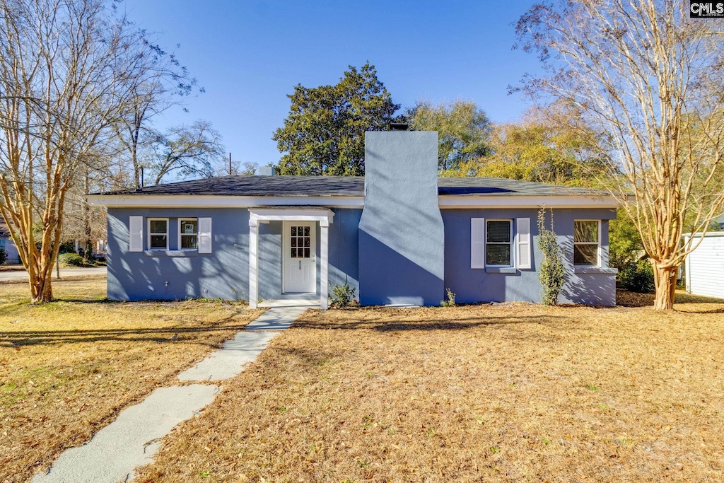 ranch-style house with a front lawn