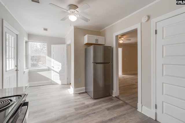 kitchen with ceiling fan, crown molding, light hardwood / wood-style floors, white cabinetry, and stainless steel refrigerator