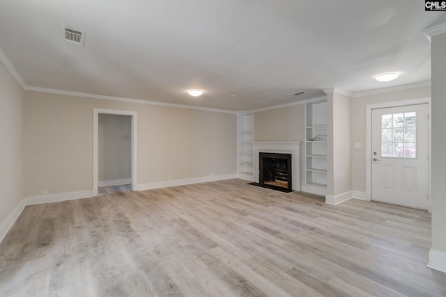 unfurnished living room with built in shelves, light hardwood / wood-style flooring, and ornamental molding