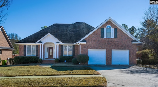 front of property featuring a front lawn and a garage