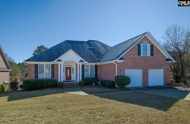 view of property featuring a garage and a front lawn