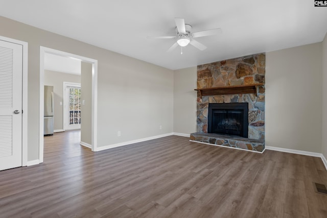 unfurnished living room featuring a fireplace, hardwood / wood-style flooring, and ceiling fan