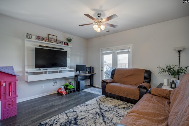 living room featuring dark hardwood / wood-style flooring and ceiling fan