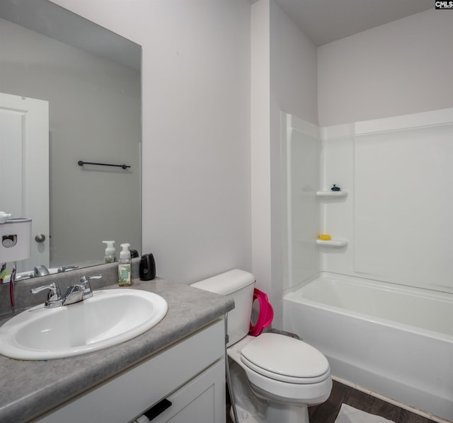 full bathroom featuring vanity, toilet, wood-type flooring, and bathtub / shower combination