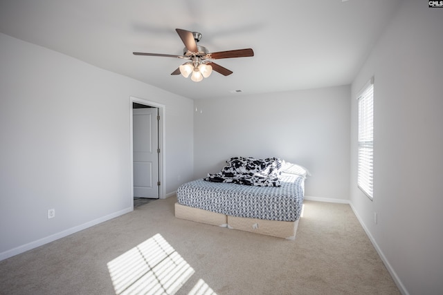 bedroom with ceiling fan and light carpet