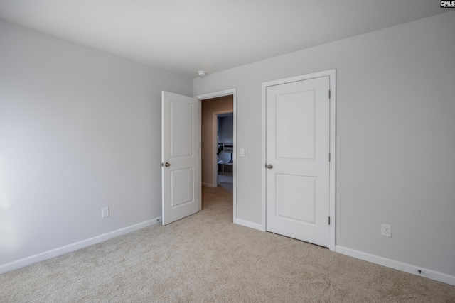 spare room featuring light colored carpet