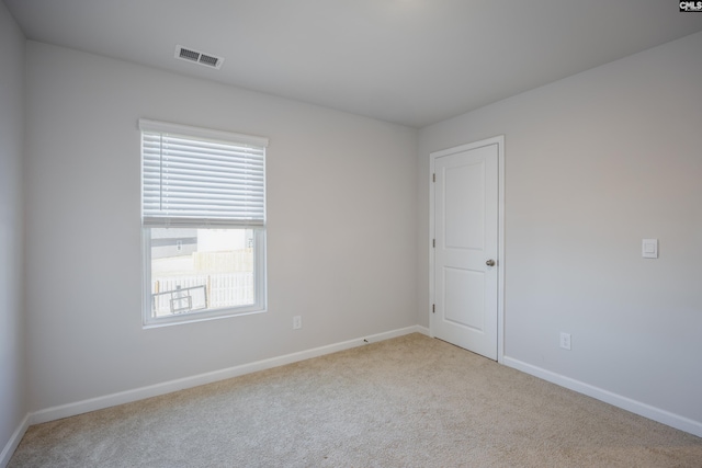 unfurnished room with light carpet