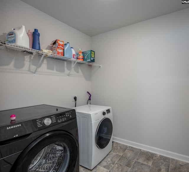 washroom with washing machine and clothes dryer