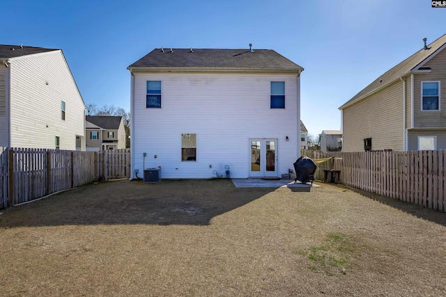 rear view of house with a patio area, central air condition unit, and french doors