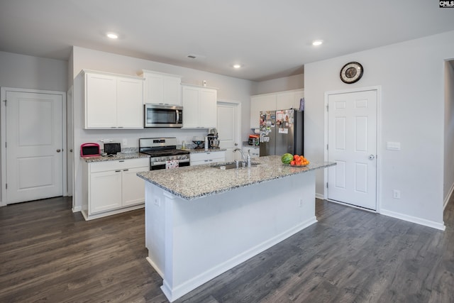 kitchen with white cabinetry, a kitchen island with sink, and appliances with stainless steel finishes