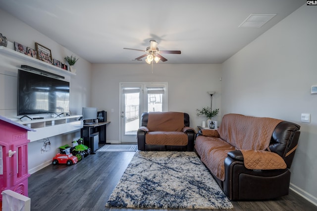 living room with ceiling fan and dark hardwood / wood-style flooring