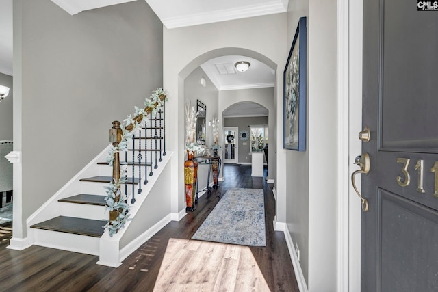 foyer featuring crown molding and dark wood-type flooring