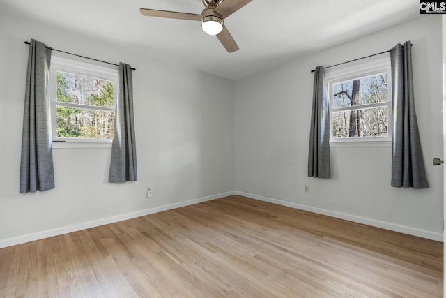 spare room with light hardwood / wood-style floors, plenty of natural light, and ceiling fan