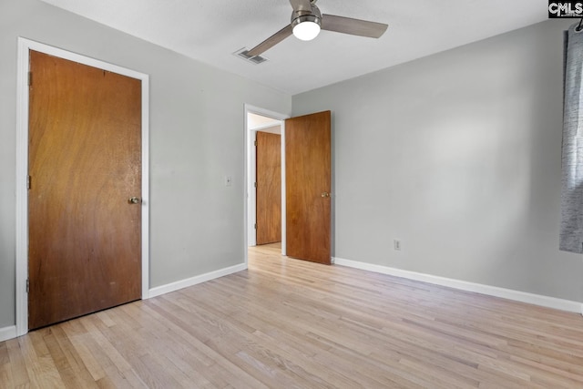 unfurnished bedroom with ceiling fan, light hardwood / wood-style floors, and a closet