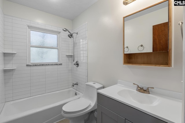 full bathroom with toilet, vanity, and tiled shower / bath