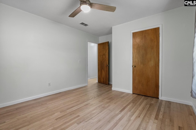 unfurnished bedroom with a closet, light hardwood / wood-style floors, and ceiling fan